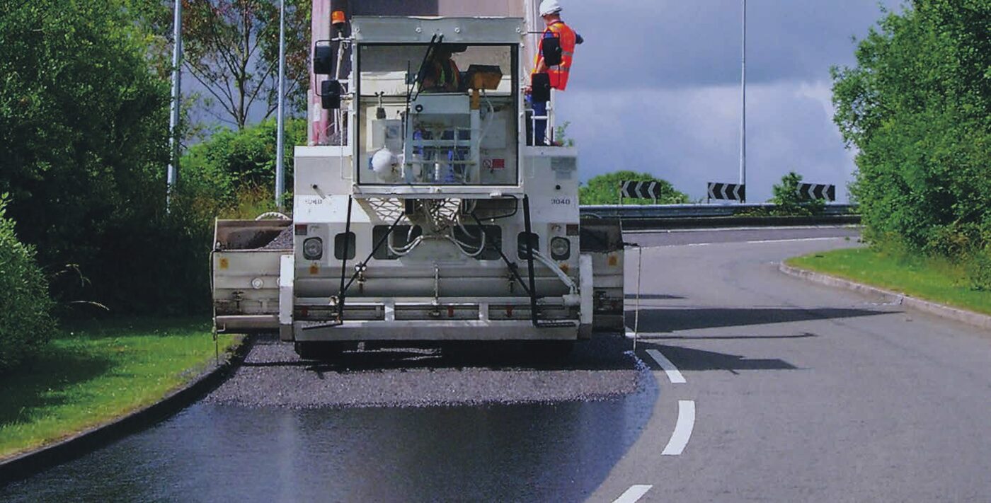 Bowser spraying bitumen emulsion prime coat on a road base