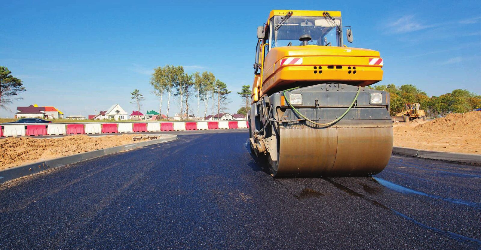 Road roller compacting a freshly laid asphalt surface